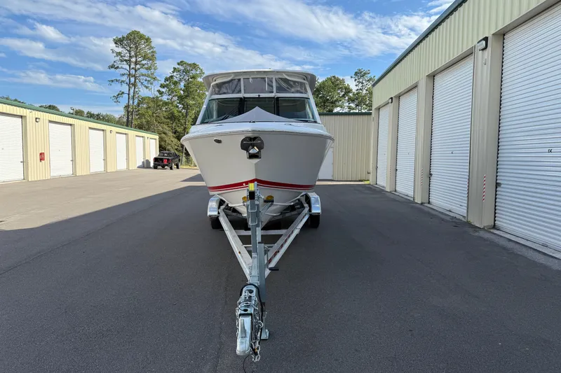 Slide: The Image of 2024 Pursuit DC 266 Dual Console boat on trailer in storage facility. - 44