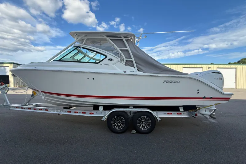Slide: The Image of 2024 Pursuit DC 266 Dual Console boat on trailer under blue sky. - 48