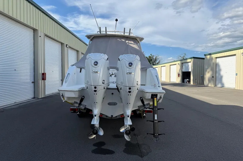 Slide: The Image of 2024 Pursuit DC 266 Dual Console boat with twin engines in storage facility. - 53