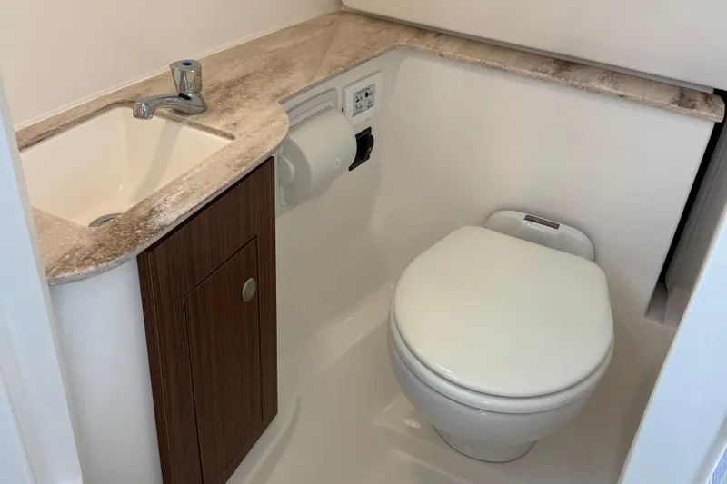 Slide: The Image of 2024 Pursuit DC 266 Dual Console boat bathroom with sink and toilet. - 56