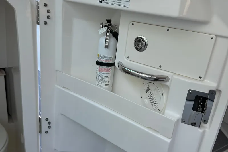 Slide: The Image of 2024 Pursuit DC 266 Dual Console interior with fire extinguisher and safety features. - 57