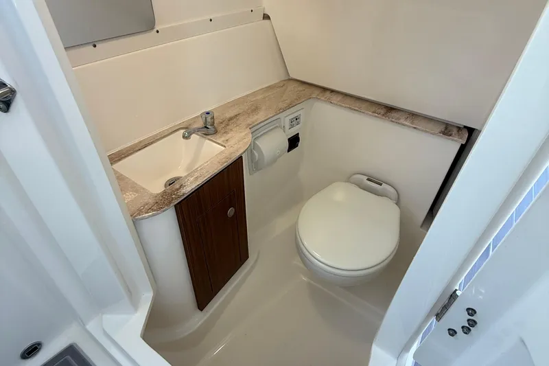 Slide: The Image of 2024 Pursuit DC 266 Dual Console boat bathroom with sink and toilet. - 58