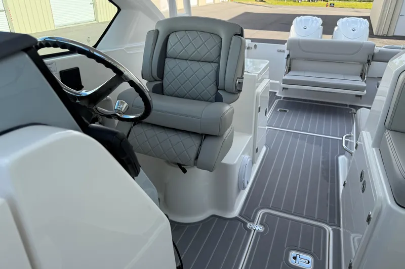 Slide: The Image of 2024 Pursuit DC 266 Dual Console interior with luxurious seating and modern design. - 9