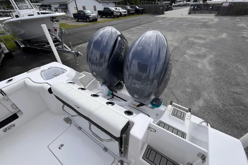 Slide: The Image of 2026 Tidewater 256 CC Adventure boat with dual outboard engines in a marina setting. - 5