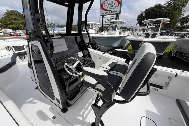 Slide: The Image of 2026 Tidewater 256 CC Adventure boat interior with Garmin navigation system and comfortable seating. - 8