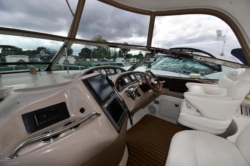 Slide: The Image of Interior cockpit of 2003 Sea Ray 460 Sundancer yacht with modern controls and seating. - 11