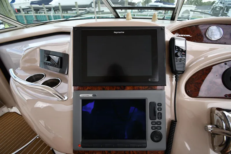 Slide: The Image of Control panel of 2003 Sea Ray 460 Sundancer yacht with navigation screens and radio. - 14