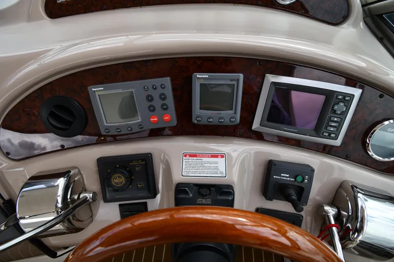 Slide: The Image of Control panel of a 2003 Sea Ray 460 Sundancer yacht with navigation instruments. - 15