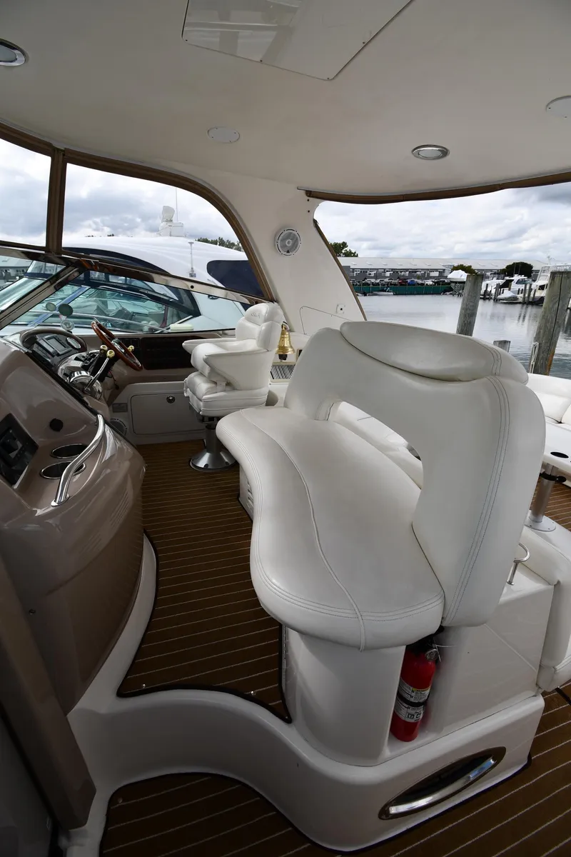 Slide: The Image of 2003 Sea Ray 460 Sundancer yacht interior with white seating and wooden flooring. - 18