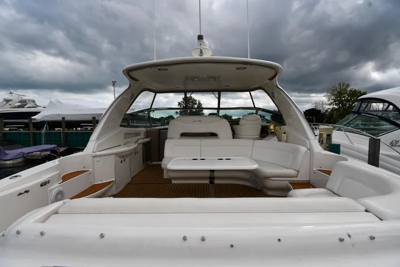 Slide: The Image of 2003 Sea Ray 460 Sundancer yacht with spacious seating under cloudy skies. - 23