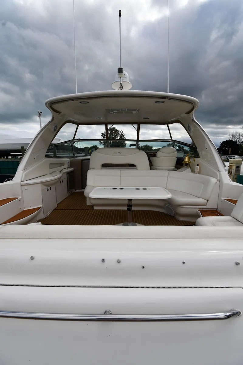 Slide: The Image of 2003 Sea Ray 460 Sundancer yacht with spacious deck and seating area under cloudy skies. - 24