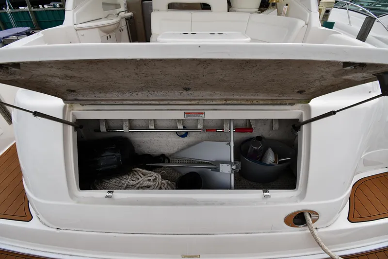 Slide: The Image of Open storage compartment on a 2003 Sea Ray 460 Sundancer yacht, showing ropes and equipment. - 27