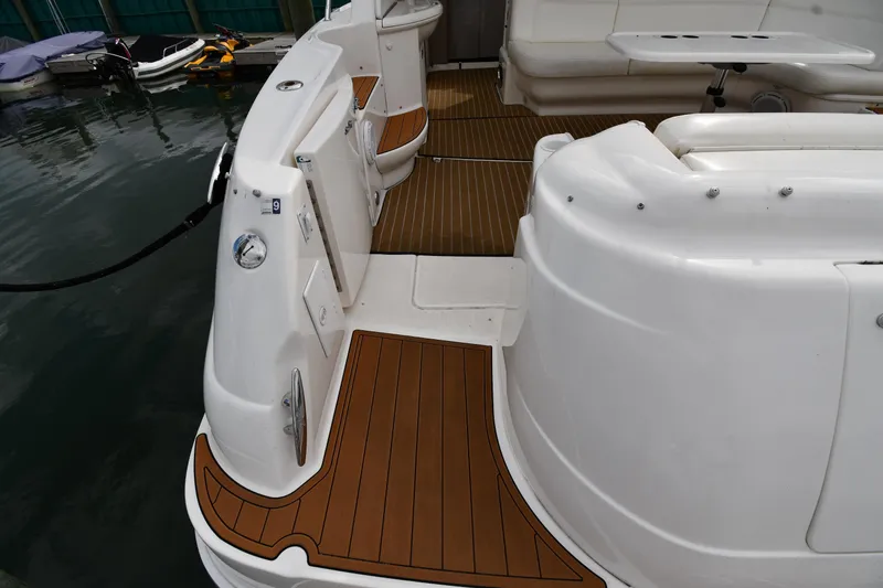 Slide: The Image of 2003 Sea Ray 460 Sundancer yacht deck with teak flooring and seating area. - 28