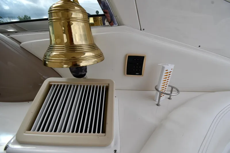 Slide: The Image of 2003 Sea Ray 460 Sundancer interior with brass bell and ventilation grille. - 30