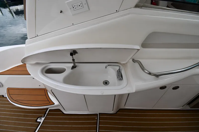 Slide: The Image of 2003 Sea Ray 460 Sundancer yacht sink area with wooden deck flooring. - 31