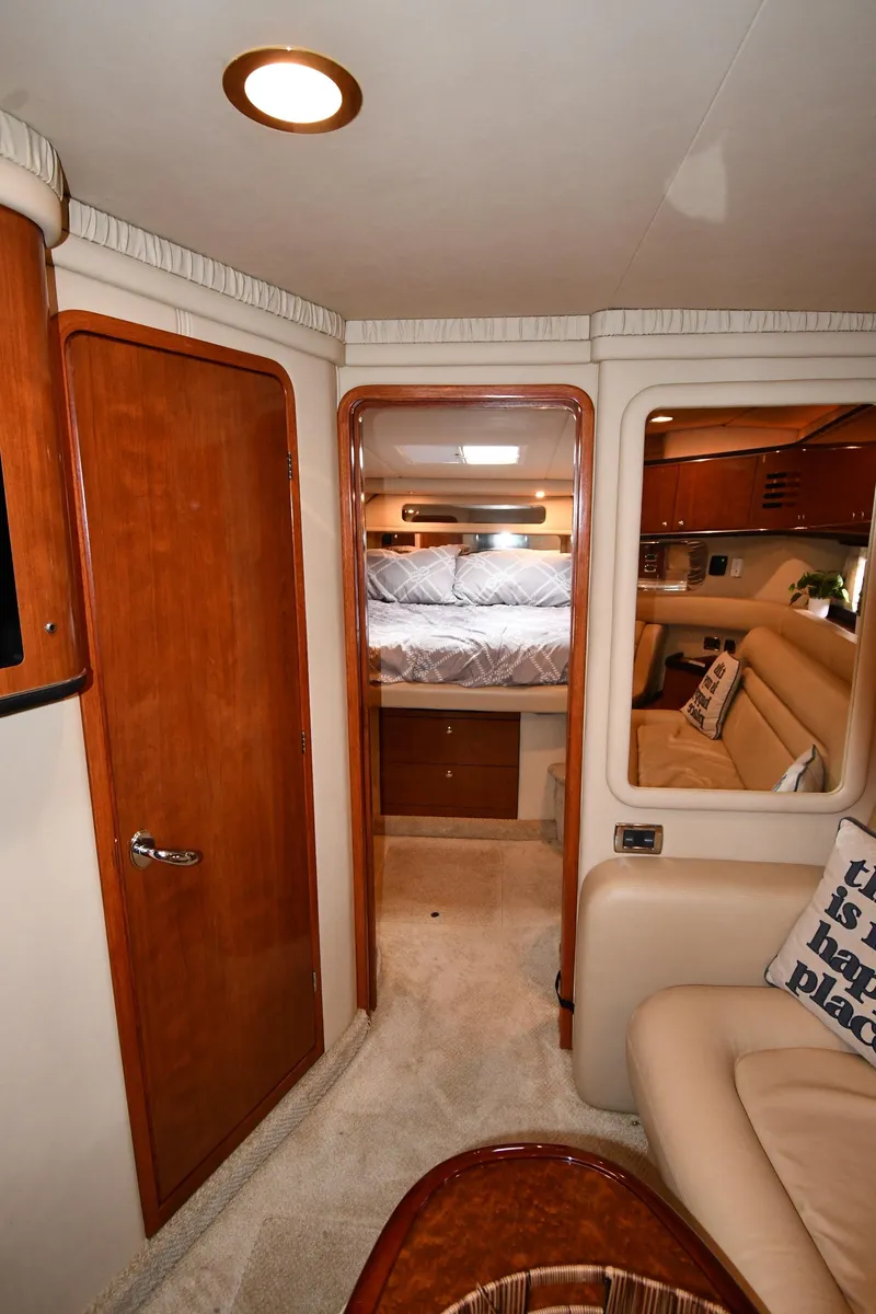 Slide: The Image of Interior of 2003 Sea Ray 460 Sundancer yacht, featuring cozy cabin and elegant wood finishes. - 34