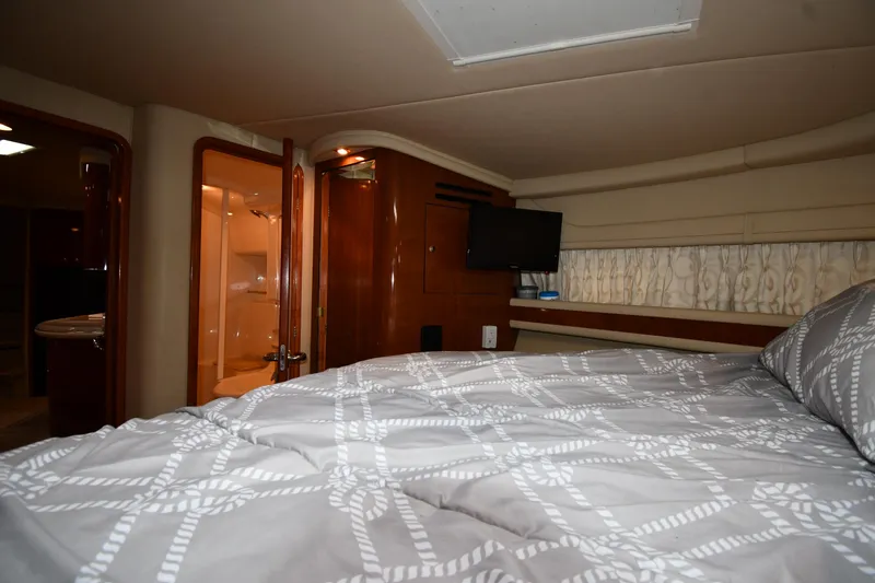 Slide: The Image of Interior cabin of 2003 Sea Ray 460 Sundancer yacht with bed and TV. - 38