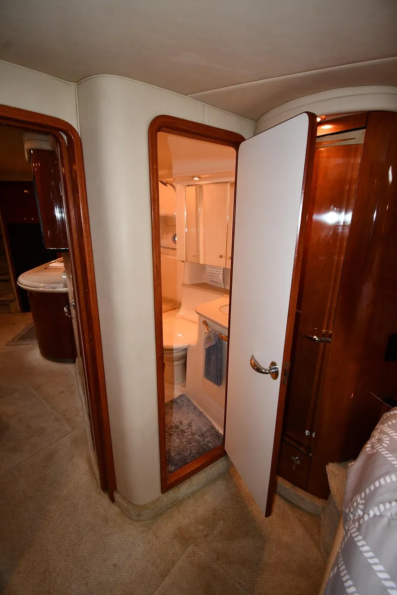 Slide: The Image of Interior of 2003 Sea Ray 460 Sundancer yacht, featuring a bathroom and wooden cabinetry. - 40