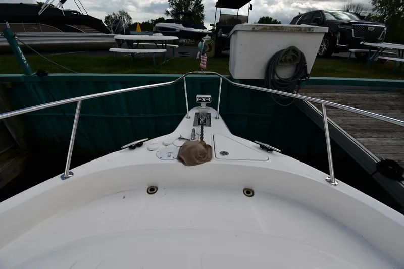 Slide: The Image of 2003 Sea Ray 460 Sundancer boat bow at dock with railing and equipment. - 6