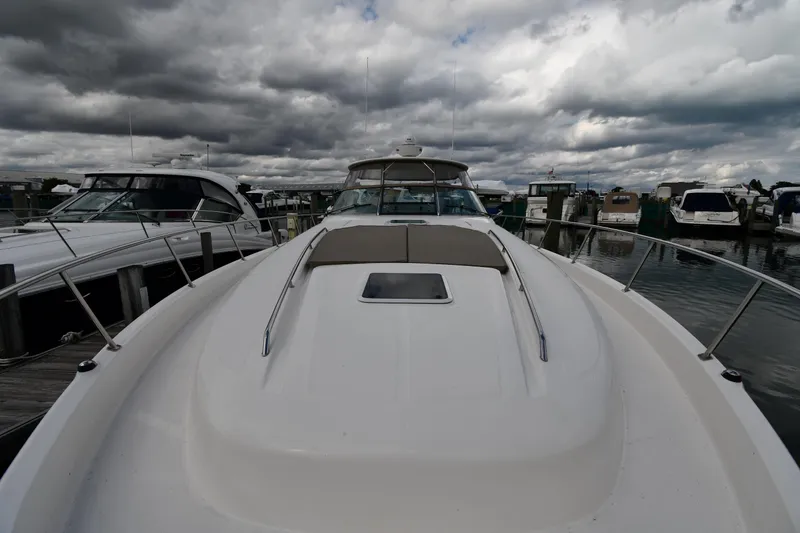 Slide: The Image of 2003 Sea Ray 460 Sundancer yacht docked under cloudy skies. - 7
