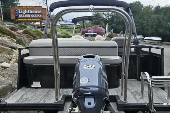 Slide: The Image of 2022 Apex Marine Qwest pontoon boat with 50 HP engine at marina dock. - 3