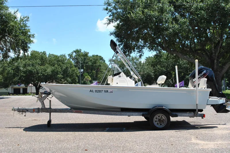 Slide: The Image of 2018 Boston Whaler 170 Montauk boat on trailer in sunny parking lot. - 12