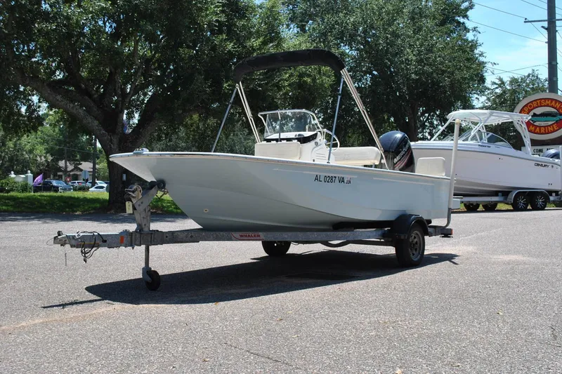 Slide: The Image of 2018 Boston Whaler 170 Montauk boat on trailer, parked outdoors. - 13