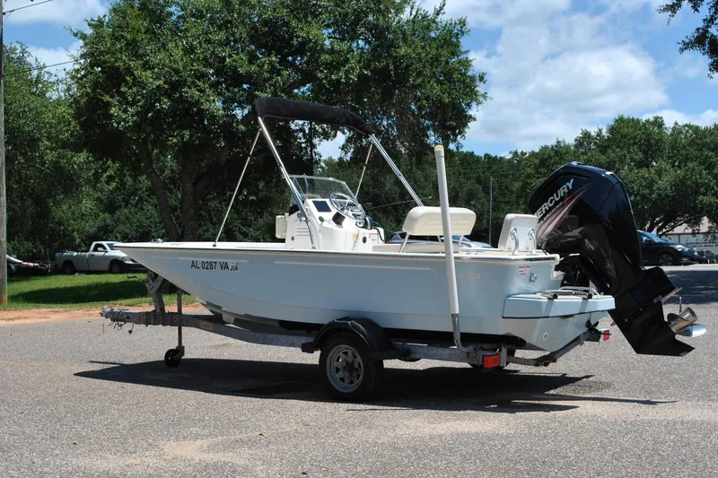 Slide: The Image of 2018 Boston Whaler 170 Montauk boat on trailer, parked outdoors. - 14