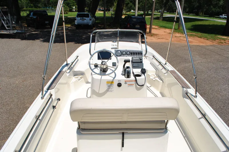 Slide: The Image of 2018 Boston Whaler 170 Montauk boat interior with steering console and seating. - 17