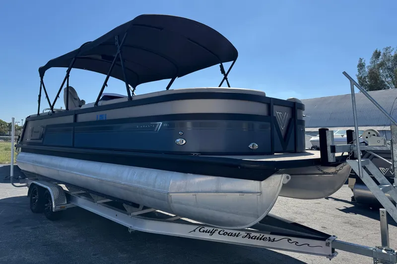 The Image of 2022 Viaggio Diamante B pontoon boat on trailer, featuring a sleek design and canopy. - 0