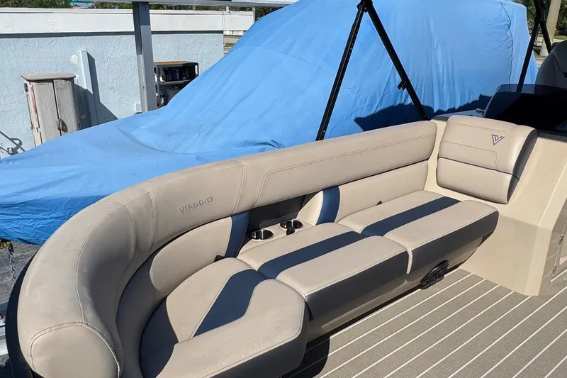 Slide: The Image of 2022 Viaggio Diamante B boat interior with beige seating and blue cover in background. - 27