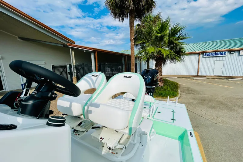 Slide: The Image of 2026 SCB R24 boat with white seating and mint green accents, parked outdoors. - 10