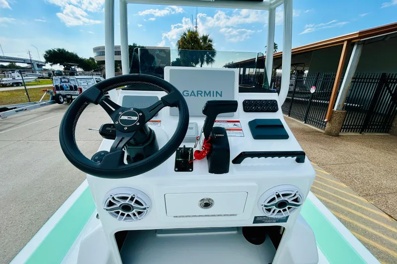 Slide: The Image of 2026 SCB R24 boat livewell with open lid, showcasing blue interior and drain. - 11