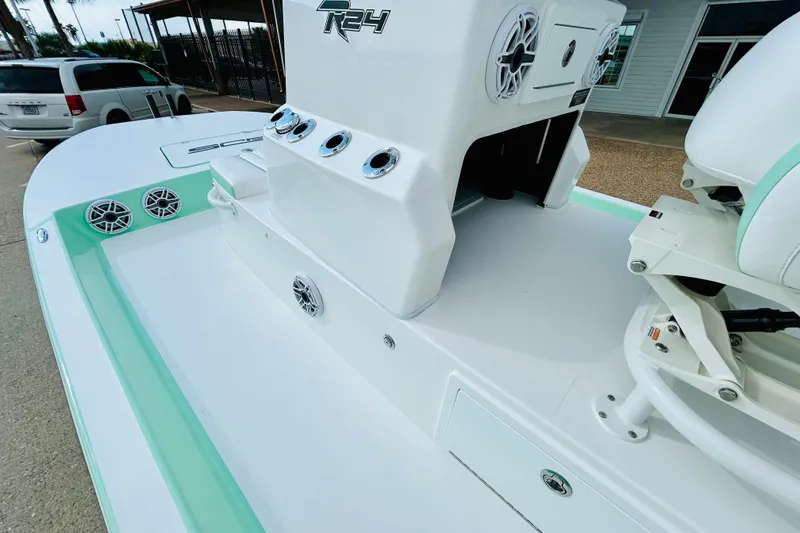 Slide: The Image of 2026 SCB R24 boat with dual seats, steering wheel, and palm trees in the background. - 12