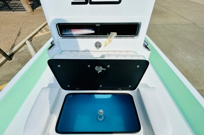 Slide: The Image of Open hatch on 2026 SCB R24 boat deck, showcasing storage compartment. - 17