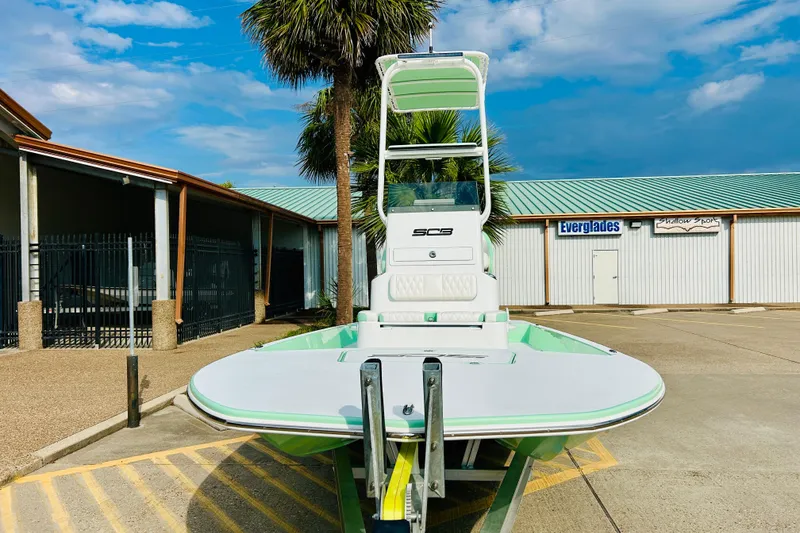Slide: The Image of 2026 SCB R24 boat on trailer, featuring Yamaha engine, parked outdoors under cloudy sky. - 2