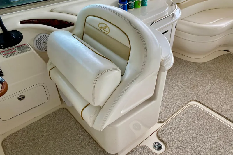 Slide: The Image of 2002 Sea Ray 290 SLX boat interior with white leather seating and dashboard. - 15