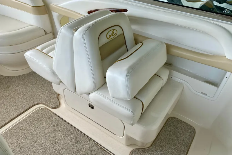 Slide: The Image of Luxury seating on a 2002 Sea Ray 290 SLX boat, featuring plush white upholstery. - 16