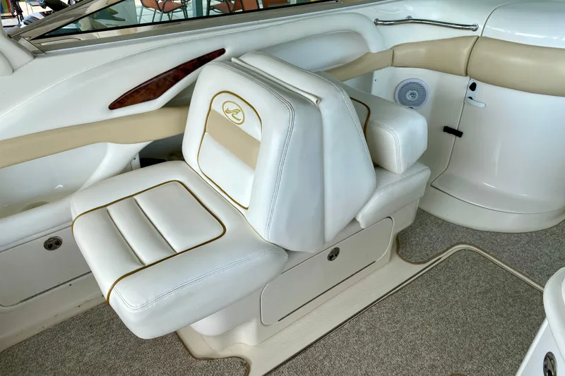 Slide: The Image of Luxurious interior seating of a 2002 Sea Ray 290 SLX boat, featuring white and beige upholstery. - 17