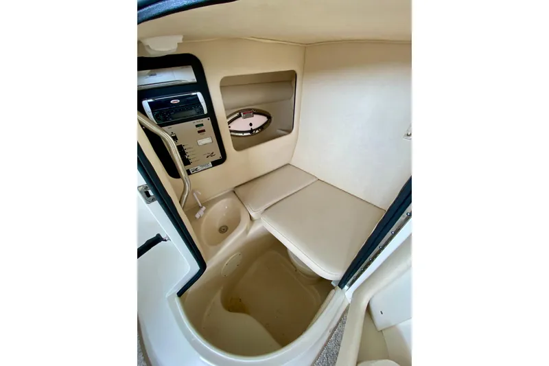 Slide: The Image of Interior cabin of 2002 Sea Ray 290 SLX boat, featuring seating and control panel. - 22
