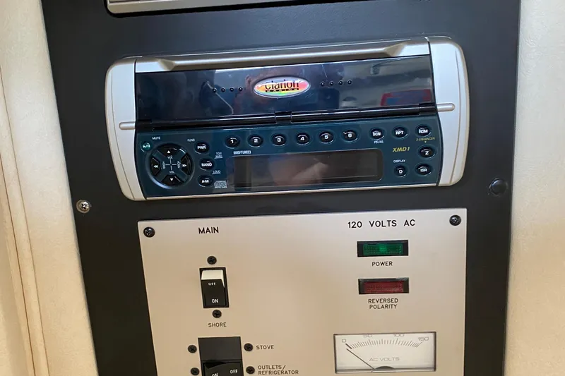 Slide: The Image of Control panel of a 2002 Sea Ray 290 SLX boat with stereo and power switches. - 23