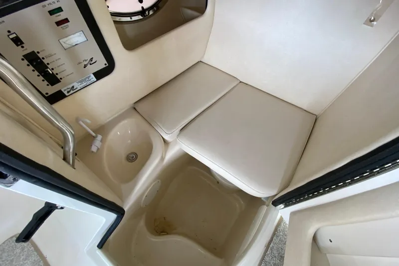 Slide: The Image of 2002 Sea Ray 290 SLX cabin interior with seating and control panel. - 24