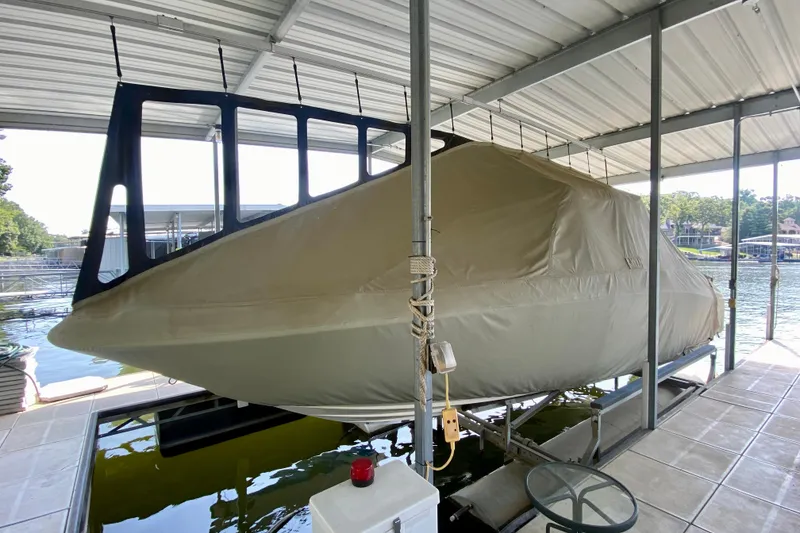 Slide: The Image of Covered 2002 Sea Ray 290 SLX boat on lift in marina dock. - 4