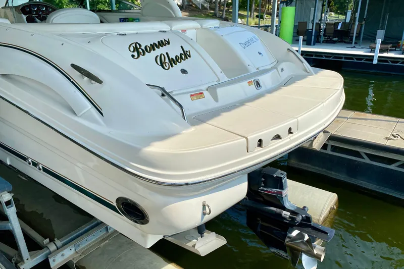 Slide: The Image of 2002 Sea Ray 290 SLX boat docked, rear view with "Bonus Check" name visible. - 6