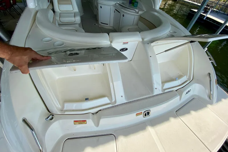 Slide: The Image of 2002 Sea Ray 290 SLX boat with open storage compartments on deck. - 7
