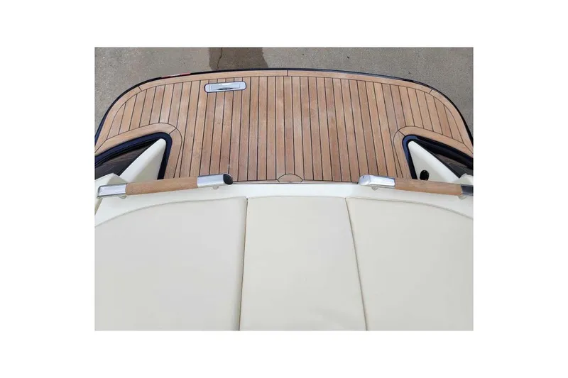 Slide: The Image of 2024 Chris-Craft Launch 27 boat with elegant wooden deck and cream upholstery. - 18