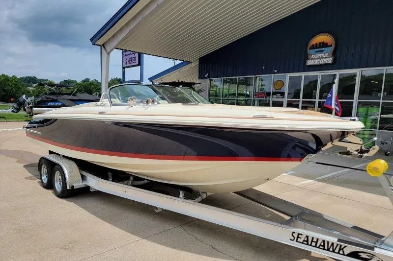 Slide: The Image of 2024 Chris-Craft Launch 27 boat on trailer at dealership, side view. - 2