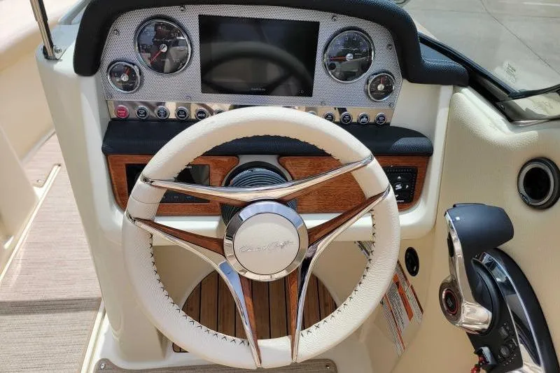 Slide: The Image of 2024 Chris-Craft Launch 27 dashboard with elegant steering wheel and modern controls. - 3