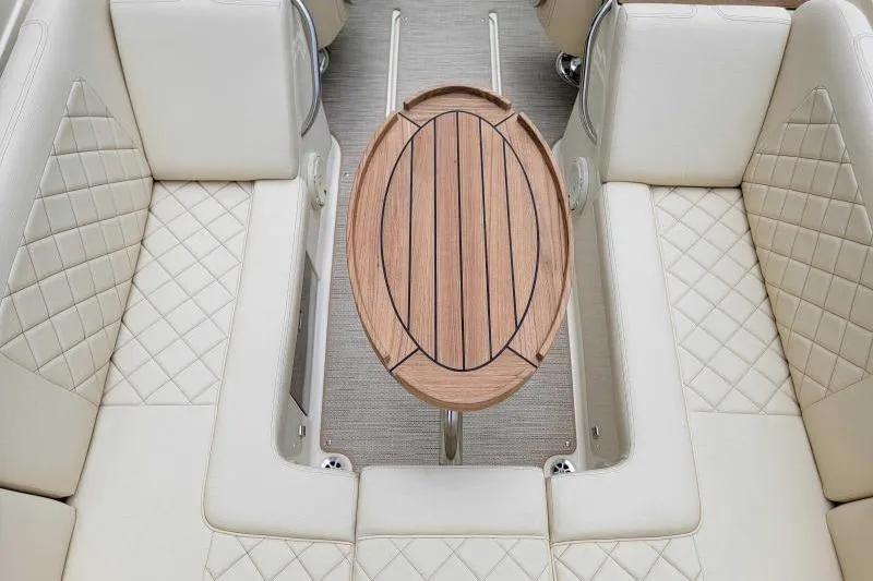 Slide: The Image of 2024 Chris-Craft Launch 27 interior with elegant quilted seating and wooden table. - 4