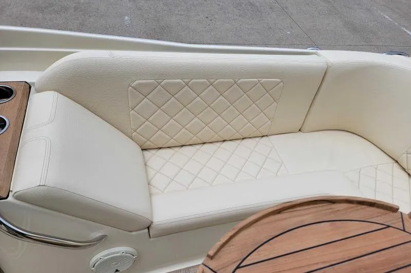 Slide: The Image of 2024 Chris-Craft Launch 27 interior with cream leather seating and wooden accents. - 5